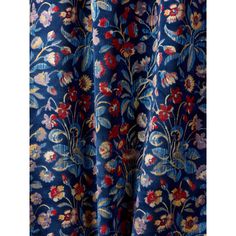 a blue floral curtain with red, yellow and pink flowers on the bottom half of it