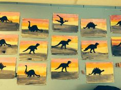 several paintings of dinosaurs are displayed on the wall in front of a child's room