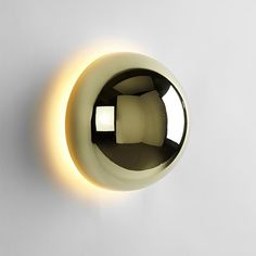 a light that is on the side of a wall with a circular object in it