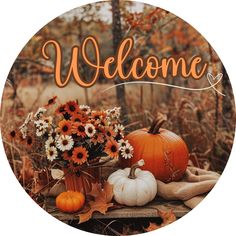 a welcome sign with flowers and pumpkins