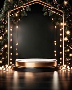 an empty stage surrounded by christmas lights and garlands with a gold podium in the middle