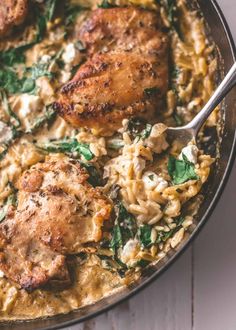 chicken and spinach casserole in a skillet with a spoon on the side