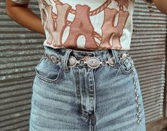 Simple silver belts are all the rage this season! Which means adding our Silver Concho Belt to your closet is a must. Wear with your favorite denim to make a statement all while showing off your western flair!   S/M is 42in end to end, but you can adjust the last 7-8in (Pendant 16pcs) L/XL is 45.5in end to end, but you can adjust the last 7-8in (Pendant 18pcs)  Model is wearing S/M. Silver Western Belt, Conch Belt Outfit Western, Concho Belt Outfit, Western Belts Outfit, Country Belts, Belt Outfit, Cowgirl Aesthetic, Rodeo Outfits, Concho Belt