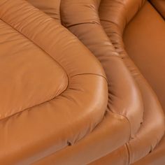 a close up view of the back end of a reclining chair with brown leather