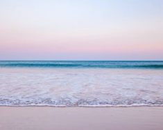 the ocean waves are rolling in to shore