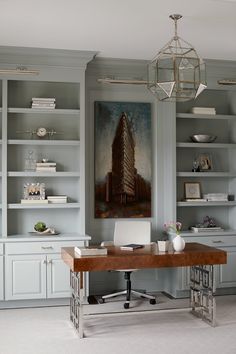 a home office with built in bookcases and a painting on the wall