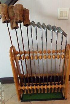 an old wooden rack with golf clubs in it