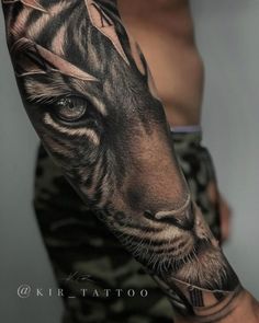 a man's arm with a tiger tattoo on the left side of his body