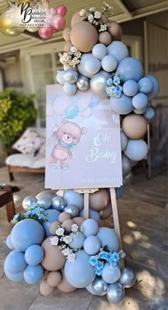 balloons are arranged in the shape of a baby's first birthday sign and teddy bear