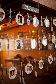 there are many pictures hanging on the clothes line