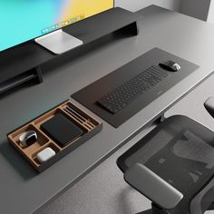 an office desk with a keyboard, mouse pad and other items on the table next to it