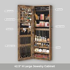 an open wooden jewelry cabinet with labels on the doors and compartments for all kinds of items