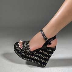 Elevate your style with our Naomi In Black/Gold Rope Wedge. Made with high-quality materials, this wedge features a unique black and gold rope design that adds a touch of elegance to any outfit. Expertly crafted for comfort and durability, these wedges are the perfect addition to your wardrobe. Material: Synthetic Rope Leather Insole Heel: Apron 5 inches Platform: Approx 2 inches Black High Heel Wedge Sandals For Vacation, Black Wedge Sandals With Woven Sole, Black Straw Heels For Spring, Spring Black Straw Heels, Black Open Toe Straw Wedge Sandals, Black Open Toe Wedge Sandals With Straw Material, Black Straw Open Toe Wedge Sandals, Black Synthetic Wedge Sandals With Wrapped Heel, Black Wedge Sandals With Wrapped Heel