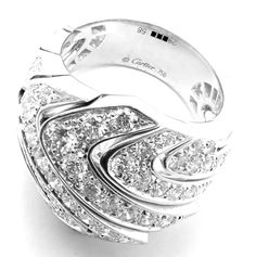 This Cartier ring is a luxurious 18k white gold piece, featuring an elegant wave design studded with sparkling diamonds. The undulating form of the ring mimics the serene movement of the ocean, while the diamonds add a sophisticated glimmer, reflecting Cartier's hallmark of timeless elegance and craftsmanship.This ring comes with original Cartier box. Metal: 18k White Gold Ring Size: European 58, US 8 1/4 Stones: 86 Round brilliant cut diamonds VVS1 clarity, E color total weight approximately 4. Luxury White Diamond Ring With Single Cut Diamonds, Luxury White Single Cut Diamond Ring, Luxury Cartier Rings In Diamond White, Cartier Platinum Diamond Ring With Prong Setting, Luxury Diamond Cut Diamond Ring For Evening, Luxury Diamond Cut Ring For Evening, Dazzling Brilliant Cut Diamond Ring For Evening, Cartier Diamond White Diamond Rings, Cartier Diamond White Fine Jewelry Diamond Ring