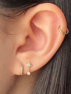 a close up of a person's ear with two piercings