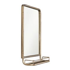 a mirror that is sitting on top of a metal stand with a shelf underneath it