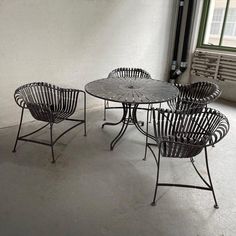 four chairs and a table in an empty room