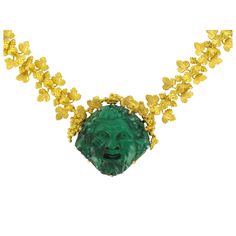 Necklace in 18K matt yellow gold necklace, eagle head hallmark. Consisting of golden vine leaves and bunches of grapes hinged together, the centrepiece of this unusual necklace is a malachite cameo of a grinning ‘Bacchus’. The clasp is a rectangular ratchet of matt gold. The cameo dates from the 19th Century, the supporting golden necklace was created by our workshop. Length: 45 cm, mesh: 1.5cm - Cameo: Length: 3.2 cm, width: 3 cm. Our opinion: This piece of jewellery was imagined and created in the Empire style, entirely by hand. The finely worked leaves and bunches of grapes beautifully enhance the wonderfully expressive malachite cameo. Specialized in antique and creation jewelry since 1975, we deliver all our jewel with their certificate of authenticity, written by our certified antiqu Unusual Necklace, Malachite Jewelry, Vine Leaves, Golden Necklace, French Empire, Grape Bunch, Yellow Gold Necklace, Eagle Head, Accessories Jewelry Necklace