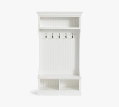 a white wooden shelf with hooks on it