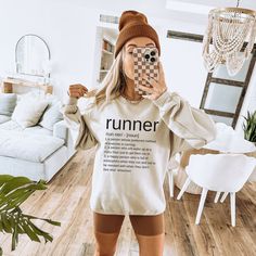 "Crafted with high-quality Gildan sweatshirt material, this minimalist Running Crewneck is designed for comfort and durability during your runs. With its classic design, it can easily be paired with any running shorts or leggings. This sweatshirt for runners is perfect for both seasoned runners and those just starting out. Its simple yet stylish design features the definition of the word \"runner\" boldly printed on the front, making a statement wherever you go. This running sweatshirt is not ju Marathon Outfit Women, Boyfriend Look, Running Partner, Talk To Strangers, Sweatshirt Graphic, Gildan Sweatshirt, White Crewneck, Grey Crewneck, Black Crewneck