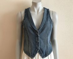 Women's Vest Blue Denim Vest Jeans Vest Fitted Womens Waistcoat Country Western Boho Womens Vest Sleeveless Denim Jacket Suit Collar  Measurements (lying flat): Length(back): 18.5"/ 47 cm Pit to pit: 16.5"/ 42 cm Waist: 15 1/4"/ 39 cm Please check measurements to insure a proper fit. Remember to allow yourself some extra room for movement. You can compare these with something from your closet that fits you well. Please convo me if you need additional measurements. Condition: great Vintage Condit Casual Denim Vest Top For Spring, Casual Spring Denim Vest Top, Spring Casual Denim Vest Top, Spring Dark Wash Denim Vest Top, Trendy Spring Denim Vest Top, Spring Sleeveless Denim Blue Denim Vest, Fitted Denim Vest With Washed Detail, Fitted Casual Denim Vest Top, Casual Fitted Denim Vest Top