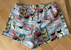 Sushi on gray background flannel sleep shorts Size small 100% cotton flannel  Enclosed elastic waistband with 1/2" non-roll elastic Low rise Side seams 2" inseam on all sizes Hip sizing:   XS(32-34"), S(35-37"), M(38-40"), L(41-43") Front rise:  XS(9 3/4"), S(10 1/2"), M(11 1/2"), L(12 3/4") Back rise:  XS(13 1/2"), S(14 1/2"), M(16"), L(16 3/4") Measurements are approximate  Sizing allows for about 2-3 inches of ease/shorts run a size smaller than the pants All seams are sewn with a serger except for topstitching on waistband and hems. Fabric is not prewashed.  Shrinkage is vertical. Best to wash in cold water separately or with like colors.  Do not soak garment.  Remove promptly into dryer on low heat.  No chlorine bleach. Note:  shorts run small Flannel sleep shorts are not returnable F Gray Pajama Shorts For Loungewear, Gray Pajama Shorts For Summer Loungewear, Flannel Shorts, M 16, Sleep Shorts, Pajama Robe, S 10, Gray Background, Cotton Flannel