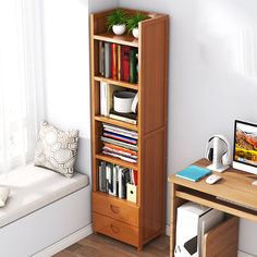 a computer desk with bookshelf next to a window