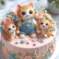 there is a cake decorated with cats and flowers on the top tier, as well as three smaller kittens