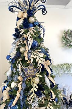 a decorated christmas tree with blue and gold decorations