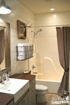 a bathroom with a sink, toilet and bathtub in the shower stall is shown