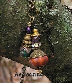 Handmade Bohemian Pumpkin Pendant Necklace, one of a kind. In celebration of Autumn in America, and in honor of the noble Pumpkin, I present these one of a kind Bohemian pumpkin charms on chains.  I use stone, glass and ceramic beads, and fire polished glass crystals, with metal findings and tarnish-free artistic wire to create these pendants. This pendant is approximately 22mm long and 10mm wide, hanging from an 18" bronze chain. This charm has a deep rust colored pumpkin and olive green Czech glass crystals on bronze and gold findings. These are one of a kind items, and as such, each one is a little different. They are made for use as pendants on a necklace chain but can be used in home décor, hanging from planters or to catch the sunlight in a window. 'Cucurbita pepo pumpkins are among Unique Charm Necklace As Gift, Artisan Necklace With Charms And Round Pendant, Artisan Necklace With Round Pendant Charms, One Of A Kind Bronze Necklace For Festival, Unique Bronze Necklace For Festivals, Artisan Necklaces For Festivals, Spiritual Nickel-free Necklaces For Jewelry Making, Artisan Pendant Necklace With Charms, Handmade Spiritual Necklaces For Festivals