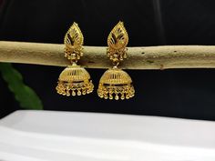 "This Pretty Traditional Pair of Earrings in gold plated Alloy Material. Design: Floral Pattern Color-Gold. Material-Metal/Alloy Size: 2 Inches Long X 1 Inches Wide ( approx.). Obsessed with Indian Jewelry! This is traditional gold-tone jewelry which is carved from our Indian artist. This jewelry are great touch on your collection.  Color may be difference because in few cases color may be different from monitor setting. About Us:  Being of Indian background, has always loved and been inspired b Yellow Gold Jhumkas With Latkans For Wedding, Gold-plated Gold Jhumkas For Formal Events, Gold Plated Jhumkas For Formal Events, Gold Plated Gold Jhumkas For Formal Occasions, Gold Temple Jewelry Jhumkas For Wedding, Festive Yellow Gold Jhumkas For Wedding, Gold Bridal Earrings For Marriage And Festivals, Gold Earrings With Intricate Design For Wedding, Gold Chandbali Jhumkas For Marriage