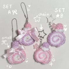 three pink and white crocheted flowers with stars on them are hanging from chains