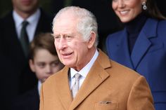 an older man in a suit and tie standing next to other people