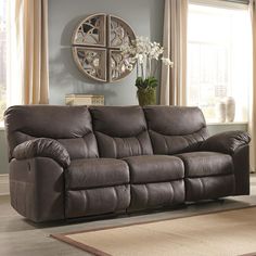 a living room scene with focus on the reclining sofa