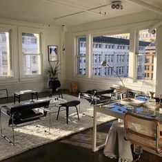 a living room filled with furniture and lots of windows