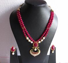 A double layered dark pink semi precious stone necklace Cheap Pink Jewelry With Black Beads, Elegant Pink Pearl Necklace For Festivals, Pink Kundan Necklace With Round Beads, Elegant Pink Beaded Necklaces For Festivals, Pink Temple Jewelry Necklace With Round Beads, Pink Temple Jewelry Style Beaded Necklace As Gift, Pink Kundan Necklace With Round Beads For Festivals, Handmade Pink Temple Jewelry Necklace, Handmade Pink Temple Jewelry Sets