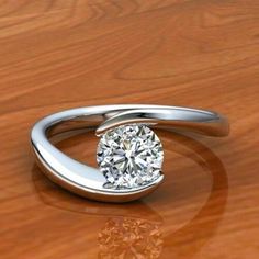 a diamond ring sitting on top of a wooden table