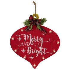 a red christmas ornament with merry and bright written on the front, hanging from a string