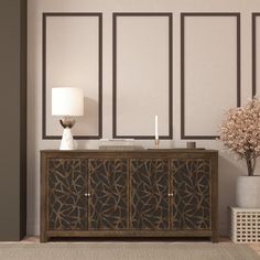 a living room with a table, lamp and vase on the sideboard in front of it