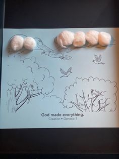 three cotton balls on top of a book with the title god made everything written below