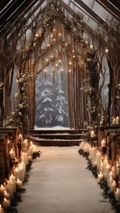 an outdoor ceremony with candles and flowers on the aisle, surrounded by snow covered trees