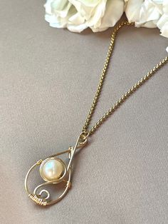 "Wear this necklace for its elegant handmade freshwater pearl teardrop wire handmade pendant. Great for holiday gift, gift for mom, gift for sister, gift for wife, gift for girlfriends, etc.! 1.5\" total pendant height freshwater pearl non tarnish 20\" cable chain necklace hypoallergenic 18k gold plated" Elegant Handmade Pear-shaped Necklaces, Gold Wire-wrapped Drop Necklace As Gift, Gold Wire-wrapped Drop Necklace For Gift, Handmade Teardrop Necklace For Her, Elegant Teardrop Wire Wrapped Necklaces, Elegant Wire Wrapped Teardrop Necklaces, Gold Wire Wrapped Drop Necklace As Gift, Elegant Wire Wrapped Teardrop Necklace, Gold Wire Wrapped Drop Necklace For Gift