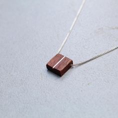 This handcrafted dainty square walnut pendant is made with a silver inlay paired with an adjustable sterling silver threader chain(16-22in) perfect for any style you choose to wear it with. Minimalist Brown Necklace For Gift, Minimalist Brown Necklace For Gifts, Minimalist Brown Necklaces For Gifts, Brown Square Pendant Jewelry For Gift, Minimalist Brown Jewelry For Gift, Minimalist Brown Jewelry As A Gift, Minimalist Brown Jewelry As Gift, Brown Rectangular Pendant Necklace As Gift, Adjustable Rectangular Sterling Silver Necklace