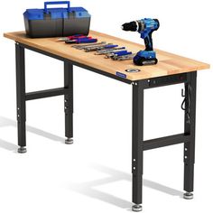 a workbench with tools on it and a tool box sitting on the table