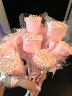 a bouquet of pink and white candy wrapped in cellophane with pearls on them