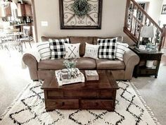 a living room filled with furniture and a large clock on the wall above the coffee table