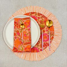 an orange and white plate topped with two forks