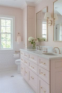 a bathroom with pink walls and white tile on the floor, along with two sinks