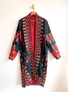 Fantastic traditional Turkmen robe/duster. Vivid colors and carefully embroidered workmanship. One of the best examples of this type of traditional wear we have come across. Infinitely wearable and looks great with jeans and boots. Add flair to a jeans and t uniform. Fabric: cotton/silk/ otherFit: S/MEra: 1940's Measurements: Bust 48" Sleeve (from collar) 32" Length 43" Waist 48" Hips 52" Condition: Excellent Traditional Fitted Outerwear With Embroidered Border, Fitted Traditional Outerwear With Embroidered Border, Traditional Long Outerwear With Resham Embroidery, Traditional Long Outerwear With Floral Embroidery, Festive Long Outerwear With Multicolor Embroidery, Traditional Fitted Cotton Kaftan, Fitted Cotton Traditional Kaftan, Traditional Long Embroidered Outerwear, Long Embroidered Traditional Outerwear